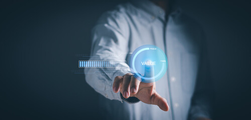 Businessman taps virtual value added icon with virtual screen, concept of value added business and...