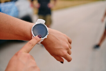 Close Up Woman Analyzing Workout Data on Smartwatch Post Run.