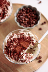 Traditional Italian dessert tiramisu in glasses on white table. Soft focus