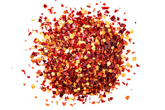 A pile of red chili pepper flakes isolated on a white background.