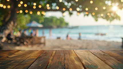 Under the Radiant Sunlight, an Empty Wooden Table Stands Adorned with Vibrant Greenery, Set Against a Beach Bustling with People Fading into a Serene Blur, Perfect for Showcasing Products or Creating 