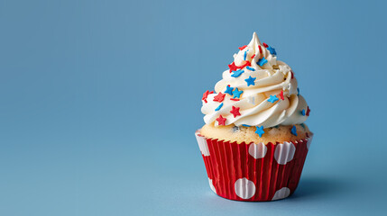 Red White and Blue 4th of July Independence Day Star Cupcake on a Blue Background with Space for Copy