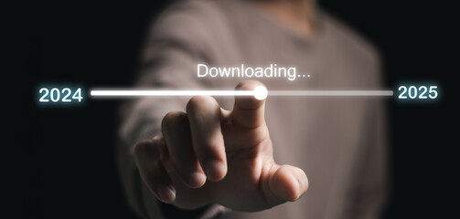 Businessman touching on download bar status to change from 2024 to 2025 for countdown of merry...