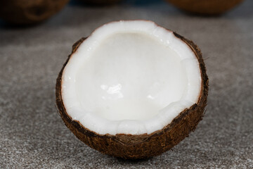 Half a coconut with coconut water inside, close-up of coconut flesh.