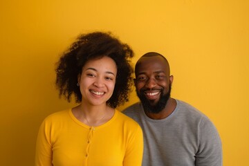 Obraz premium Portrait of a glad multicultural couple in their 30s sporting a long-sleeved thermal undershirt while standing against soft yellow background