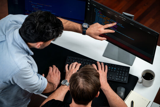 IT developers discussing online software development information on pc screen, creating program coding for latest version application on website. Concept of brainstorming firmware updated. Sellable.