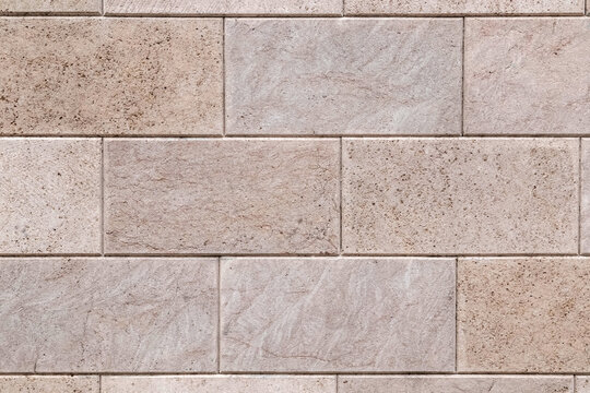 Shell stone tile wall as background. Old natural block wall with rough surface