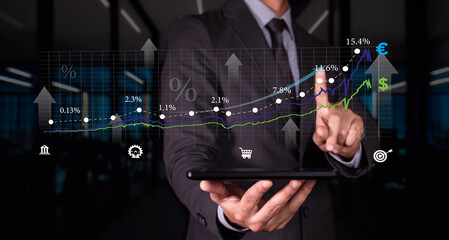 businessman with tablet in hand analyzes growth and investment charts