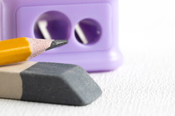 Pencil sharpener, eraser and a simple pencil on a white background. Office supplies.