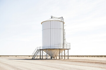 Obraz premium White Grain Silo in a Dry Desert Landscape