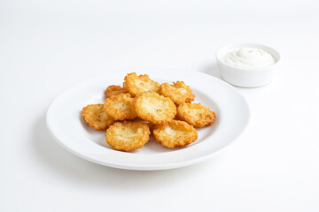 Crispy Potato Rounds with Creamy Dip on a White Plate