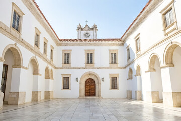 Fototapeta premium White building with arched walkways and a courtyard