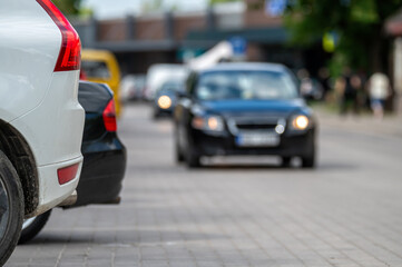 White car parked on city street. Shallow depth of feld