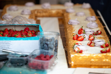 Cake decorating with berries. Shallow depth of feld