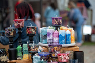 Colorful candles at a craft market. Background with selective focus and copy space.