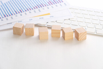 Accounting documents and empty wooden cubes