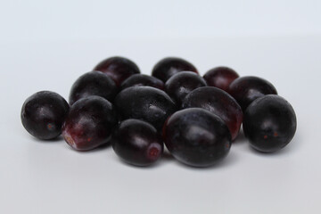 Dark purple or black grape group, off the stem, or without stalk, isolated on white background