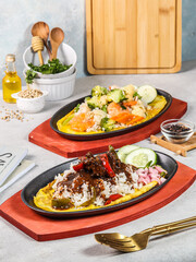 several foods such as seafood and noodles on the hotplate