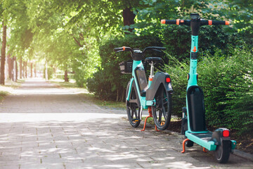 Bike and e Scooter for Rental. Bike Sharing Service.  Eco Transportation in Green City Street.  © Maryana