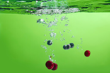 Fresh fruit falling into the water.
Organic fruits for making effective juices for dieting.
