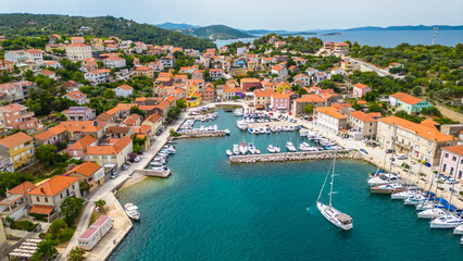 Obraz premium Sali is a picturesque village located on the island of Dugi Otok, Croatia, known for its charming harbor and serene coastal atmosphere captured by drone