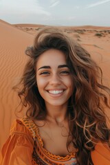 Fototapeta premium Happy woman capturing selfie in desert against clear blue sky during bright sunny day