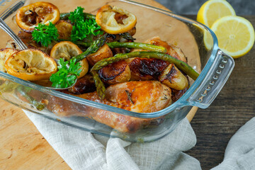 Lemon chicken drimsticks with baked potatoes and asparagus