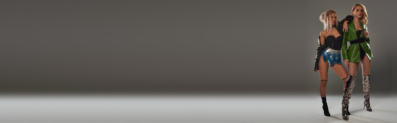 Two sexy young women standing side by side, exuding allure and confidence in their pose.