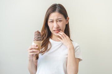 Face expression suffering from sensitive teeth and cold, asian young woman, girl hand touching...