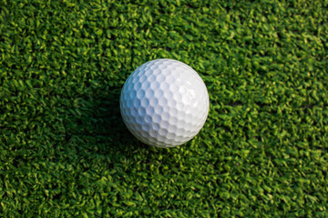 Golf ball placed on artificial grass.