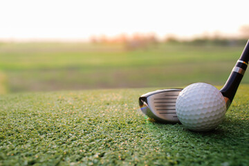 Golf is placed on artificial grass with fair light shining on it.