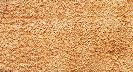 Suede texture, macro image of a tan soft suede pattern as background