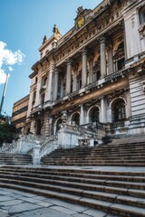 Fototapeta premium A large city hall building with a prominent clock tower visible from the front