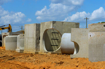 Stack of concrete drainage wells for water discharge in aconstruction site prior to their...