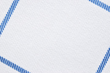 White cotton twill fabric pattern close up with blue border lines as background