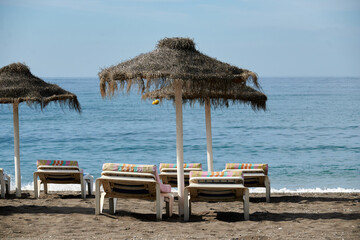 Hammocks and umbrellas on the beach under blue sky