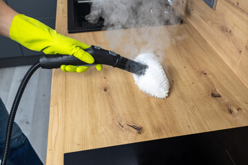 Cleaning kitchen work surfaces with steam