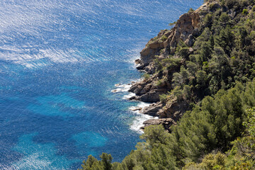 Cliffs with turquoise Mediterranean Sea, waves and wilderness in spring