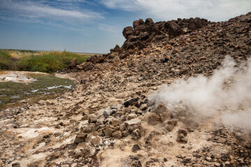 Alolabad geothermal area in Ethiopia with surreal landscape of colorful hot springs, steaming fumaroles, and erupting salt geysers in an arid, remote desert setting below sea level, Afar desert