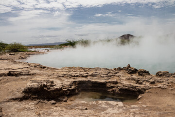 Alolabad geothermal area in Ethiopia with surreal landscape of colorful hot springs, steaming fumaroles, and erupting salt geysers in an arid, remote desert setting below sea level, Afar desert