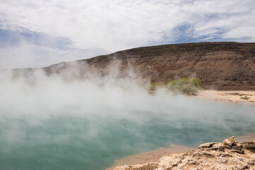 Alolabad geothermal area in Ethiopia with surreal landscape of colorful hot springs, steaming fumaroles, and erupting salt geysers in an arid, remote desert setting below sea level, Afar desert
