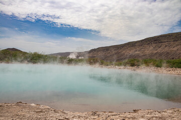 Alolabad geothermal area in Ethiopia with surreal landscape of colorful hot springs, steaming fumaroles, and erupting salt geysers in an arid, remote desert setting below sea level, Afar desert