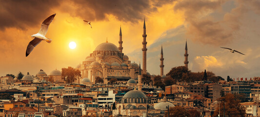 Beautiful view of gorgeous historical Suleymaniye Mosque, Rustem Pasa Mosque and buildings in front of dramatic sunset. Istanbul most popular tourism destination of Turkey. Travel Turkey concept.
 