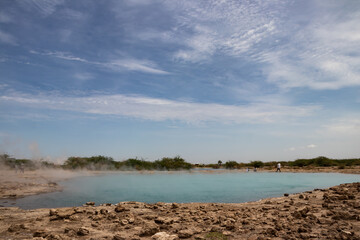 Alolabad geothermal area in Ethiopia with surreal landscape of colorful hot springs, steaming...