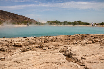 Alolabad geothermal area in Ethiopia with surreal landscape of colorful hot springs, steaming fumaroles, and erupting salt geysers in an arid, remote desert setting below sea level, Afar desert. 