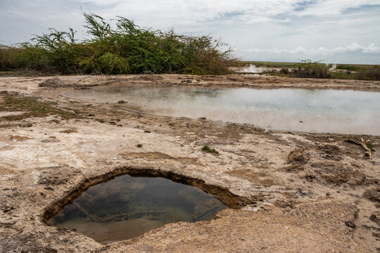 Thermal pool and pale mineral crust at Alalobad, Ethiopia