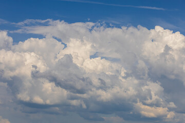 Clear blue sky with white clouds for background.