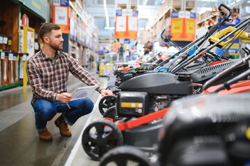 a young man in a gardening equipment store