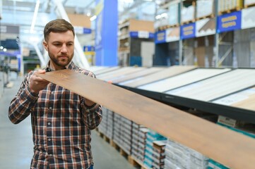 Portrait of happy mature man standing in hardware store