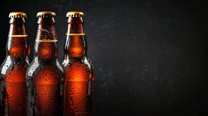 Close-up image of three beer bottles with water droplets on the surface, highlighted against a dark background